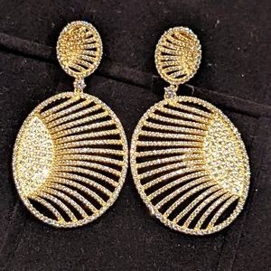Sunburst pave set cubic zirconia earrings. Gold plated 925 sterling silver.